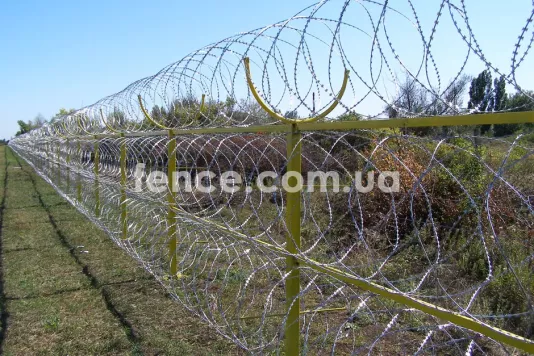 Concertina wire barrier fence